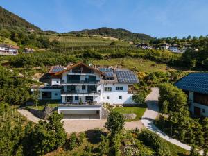 an aerial view of a house with solar panels on it at Thalerhof Naturae Oasis Ritten in Auna di Sotto