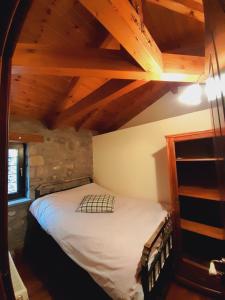 a bedroom with a bed in a room with wooden ceilings at Chalet Montagne 