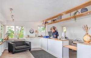 un homme debout à un comptoir de cuisine avec un ordinateur portable dans l'établissement Wildkraeuterweg 11, à Untergriesbach