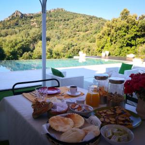 a table with food on it with a view of a mountain at Villa Maria in Dorgali