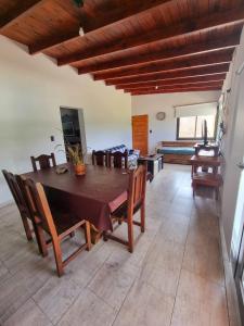 a dining room with a large wooden table and chairs at Casa en Santa Rosa de Calamuchita in Santa Rosa de Calamuchita