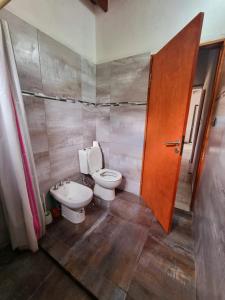 a bathroom with a toilet and a sink at Casa en Santa Rosa de Calamuchita in Santa Rosa de Calamuchita