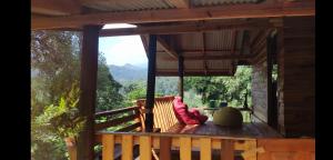 a couple sitting on the deck of a tree house at PeaMoo Homestay in Chom Thong