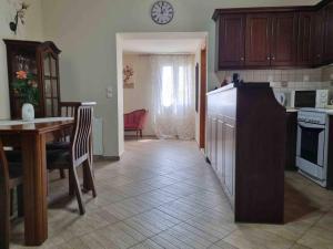 a kitchen and dining room with a table and a counter top at “Marko’s Center Beautiful House” in Corfu