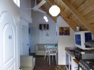 a kitchen and living room with a couch and a table at CortLang - Beach Apartments - in El Pueblito near Playa Dorada in San Felipe de Puerto Plata