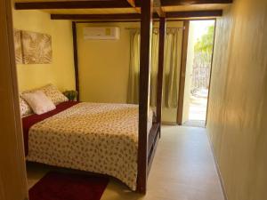 a bedroom with a bed and a door to a patio at Casa Mano Juan in Mano Juan