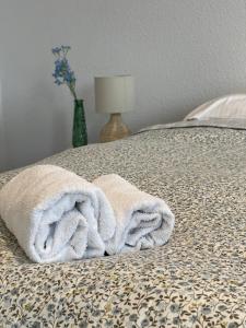 a towel sitting on top of a bed at Apartamenty Cud Miód in Krosno