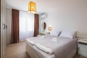 Postel nebo postele na pokoji v ubytování Kovač Family Suites