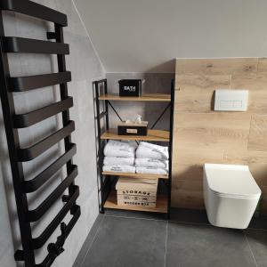 a bathroom with a white toilet and some towels at Chata Balance in Liptovská Sielnica