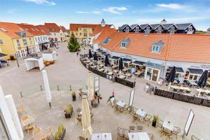 a town square with tables and chairs and buildings at Romantic And Charming Holiday Apartment In Lkken in Løkken