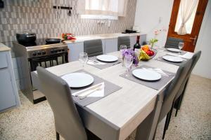 a kitchen with a table with chairs and a dining room at Spentza Home in Spetses