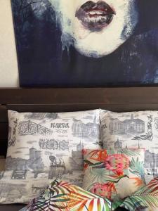 a bed with two pillows and a painting on the wall at Lada Wings 2 in Narva