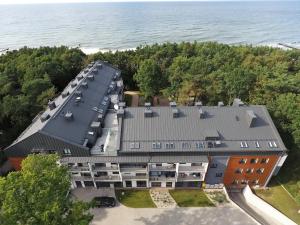 an aerial view of a building next to the water at Dwie Sosny Apartamenty Ostrowski in Ustronie Morskie