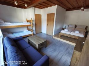 a living room with a couch and two bunk beds at Rooms Anž'k in Bled