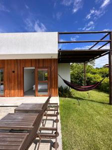 a hammock on the patio of a house at Casa Ibiza - Pipa ''Luxurious 3-Bedroom Villa with pool'' in Pipa
