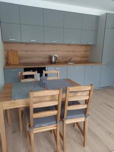 a kitchen with a wooden table and two chairs at Two room apartment with terrace, Nida in Nida