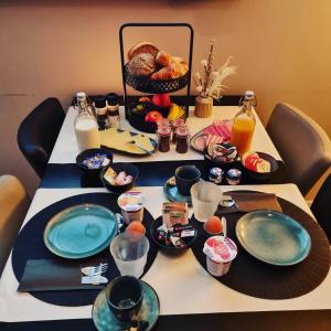 een tafel met borden eten en drinken erop bij Hotel Café de Sport in Velden