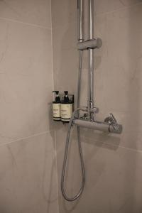 a bathroom with a shower head on a wall at Apo-Zachari elegant apartment in Larisa