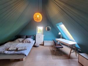 a bedroom with a bed and a desk in a tent at Landschule Rhön in Poppenhausen