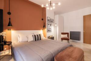 a bedroom with a large bed and a chair at Apartment with Jacuzzi Suite and 100-m2 terrace in Perugia