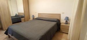 a bedroom with a bed and a mirror at Appartamenti Giglio Castello in Isola del Giglio