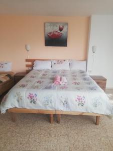 a bedroom with a bed with two dolls on it at Desert Sunrise Arad in Arad