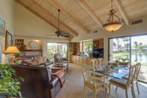 a kitchen and living room with a table and chairs at Mtn-View Rancho Mirage Condo with Lakefront Patio in Rancho Mirage