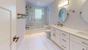 a white bathroom with a toilet and a shower at Modern 2BR 2BA with King bed-Fast Wi-Fi 75 inch OLED TV in Wilmington