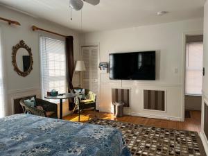 um quarto com uma cama e uma televisão de ecrã plano em Cozy House B&B em Cataratas do Niágara
