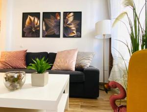 a living room with a couch and a table at Style & Design Flat in the Center of Madrid in Madrid