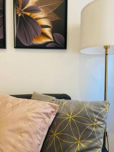 a couch with a pillow and a lamp in a room at Style & Design Flat in the Center of Madrid in Madrid