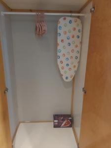 a tie hanging from a door in a closet at Romanza Studios in Vasiliki