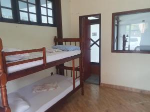 a room with two bunk beds and a mirror at vista do mar in Angra dos Reis