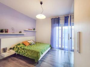 Schlafzimmer mit einem Bett mit grüner Tagesdecke in der Unterkunft Ampio Quadrilocale 8 Pax vista mare in San Benedetto del Tronto