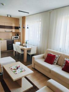 a living room with a couch and a table at Apartment Mountain view - Stará Lesná in Stará Lesná