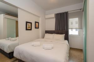 a bedroom with two beds with white sheets at Dema Luxury Suites - Lekka E3 in Athens