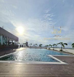 a large swimming pool in front of a building at J&A Seaview Suites in Perai