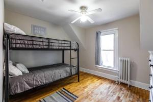 a bedroom with a bunk bed and a ceiling fan at Eagles Landing in La Crosse