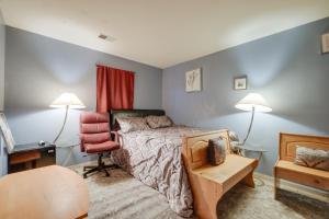 a bedroom with a bed and a chair and two lamps at Alexandria Area Vacation Rental with Backyard in Accokeek