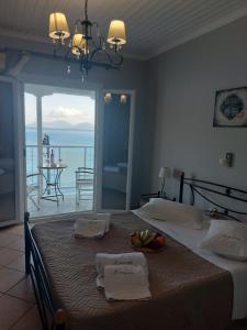a bedroom with a bed with a view of the ocean at Romanza Studios in Vasiliki