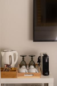a shelf with two vases and a toaster and a microwave at Dema's Luxury Suites in Athens