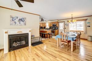 a living room with a table and a fireplace at Waterfront House on Chippewa Lake Channel in Evart