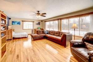 a living room with a couch and a table at Waterfront House on Chippewa Lake Channel in Evart