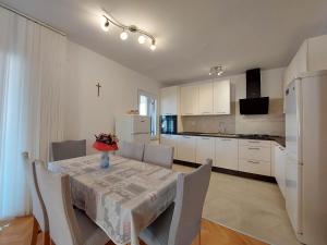a kitchen and dining room with a table and chairs at Apartment Neda in Punat
