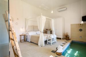 a bedroom with a bed and a swimming pool at Masseria Rauccio in Torre dell'Orso +37 photos
