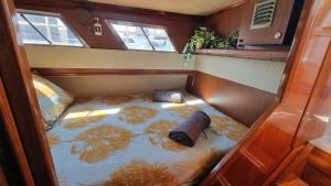 a small bed in the back of a boat at Charming boat house in Barcelona with big terrace and solarium in Barcelona