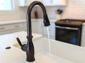 a kitchen sink with water running from a faucet at Timber Ridge in Columbia Falls +84 photos