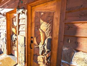 a door with a painting on the side of a house at Moose Tree Lodge in Whitefish