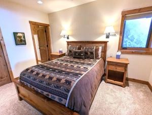 a bedroom with a large bed and a window at Eagles Nest at Elk Highlands in Whitefish