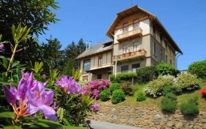 a large house with flowers in front of it at B&B Villa Tavallini in Pollone
